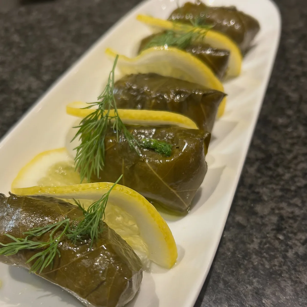 Dolmadakia — vine leaves stuffed with rice and herbs, with lemon and dill