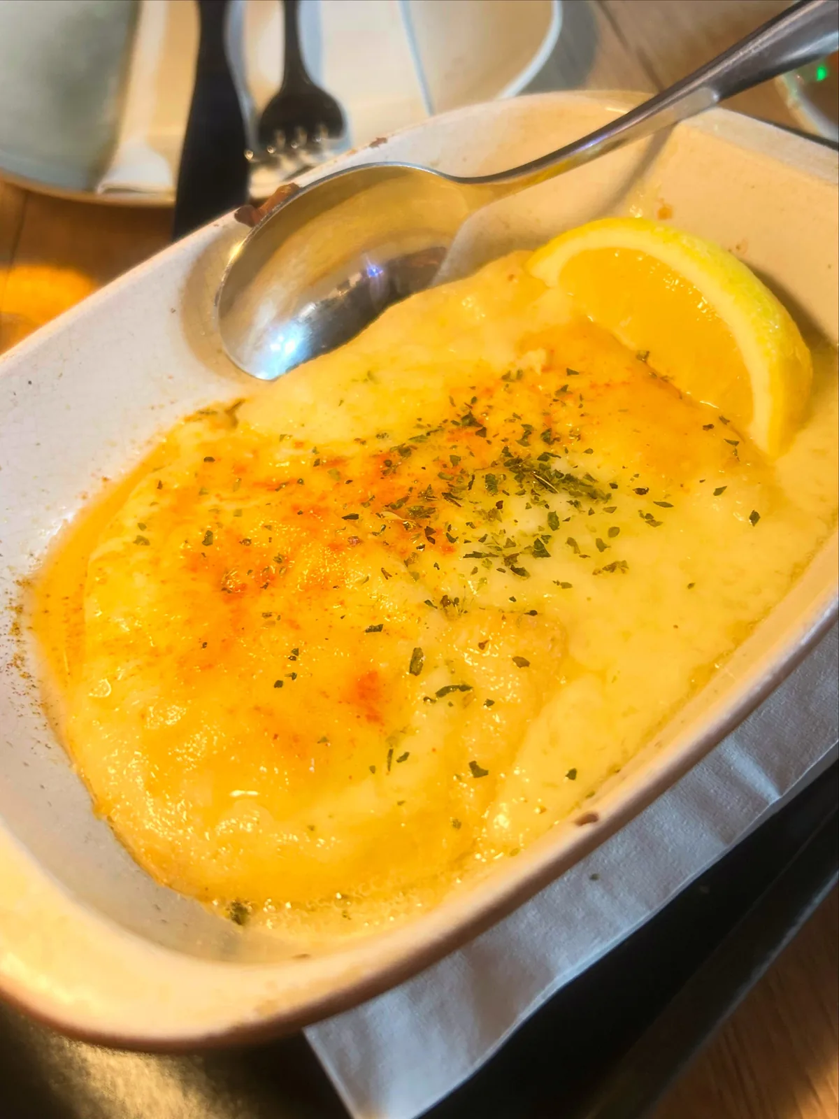 Saganaki — graviera cheese baked golden and served with lemon