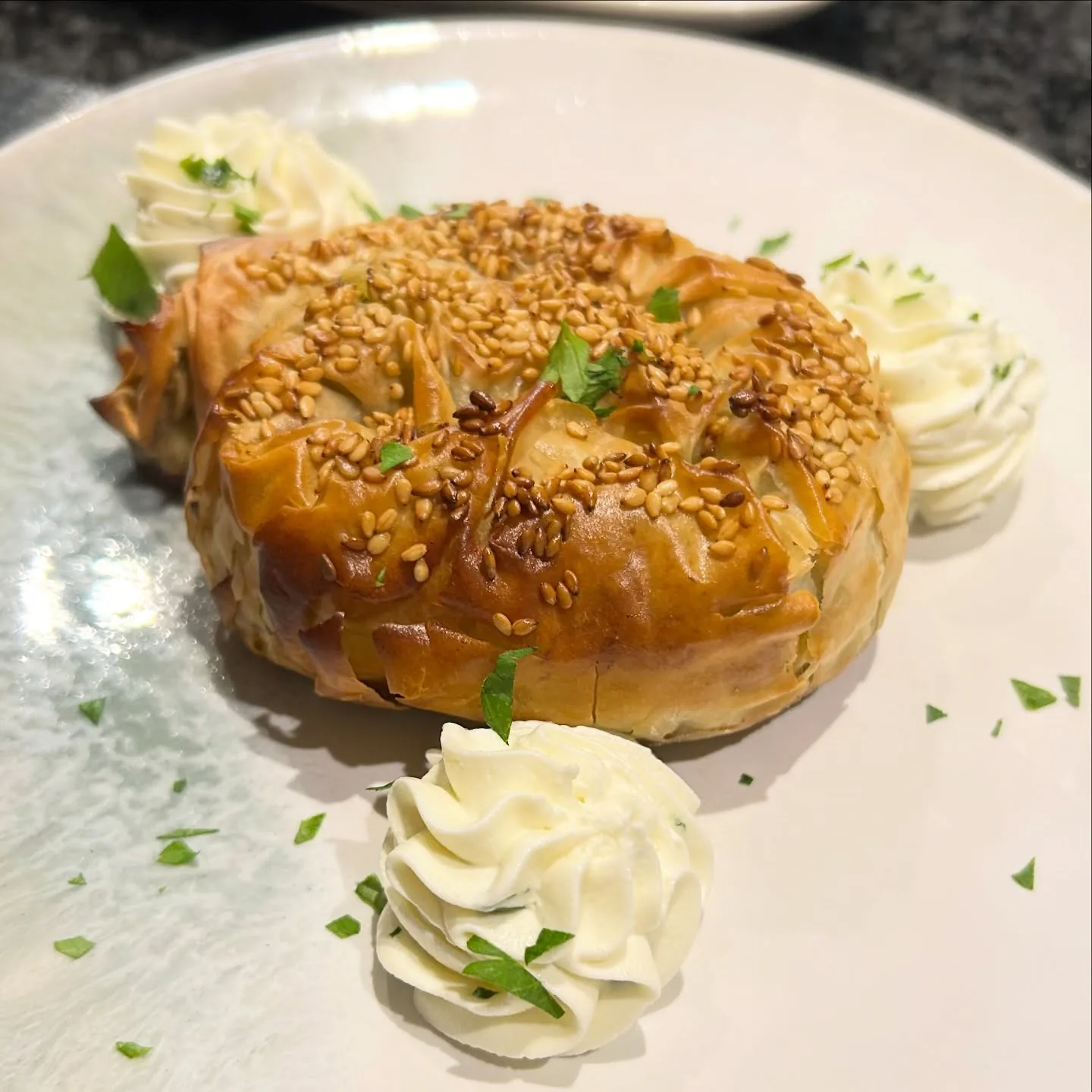 Spanakopita — crisp sesame-topped filo pastry filled with spinach and feta